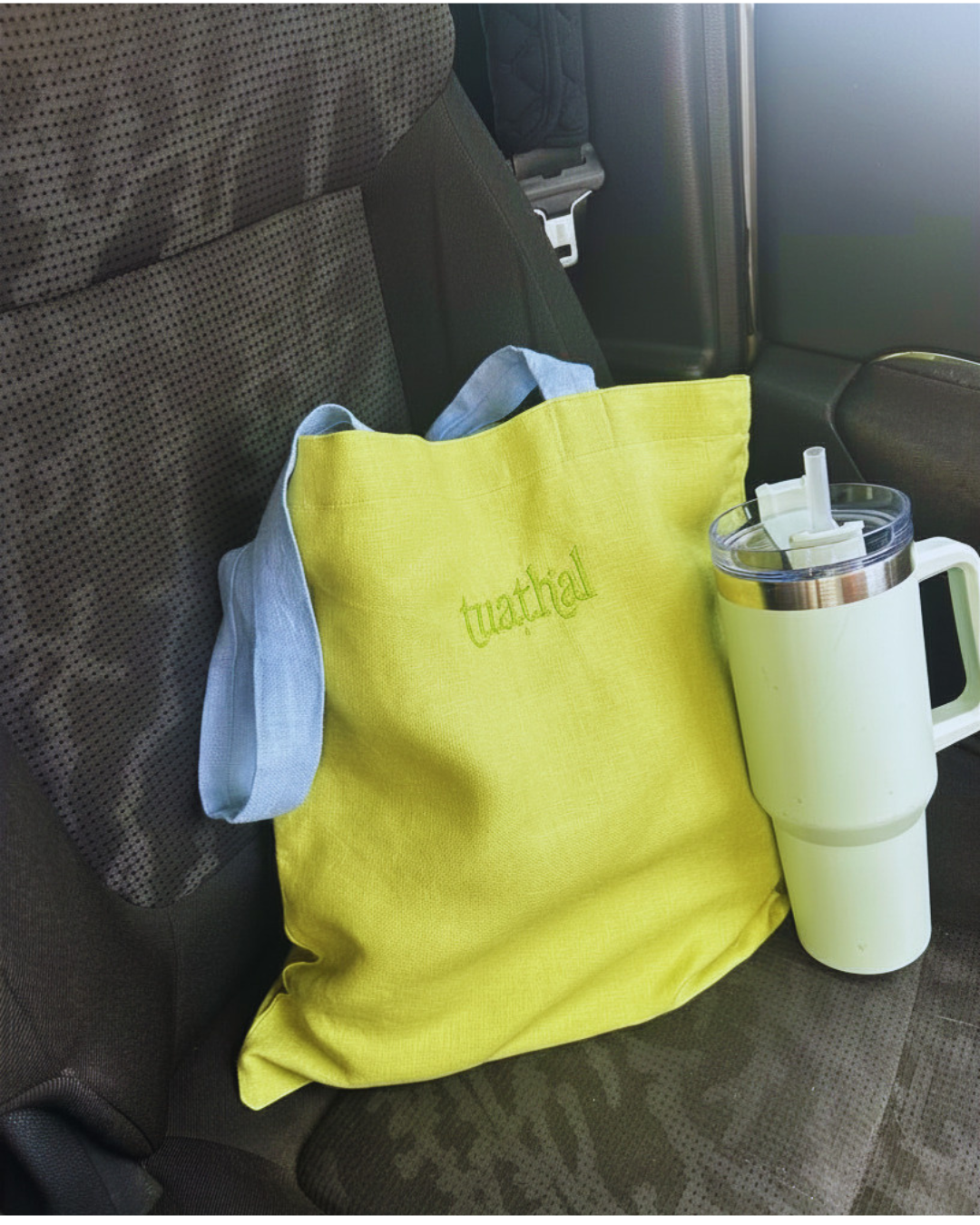 Tuathal green linen tote bag in car with water bottle 