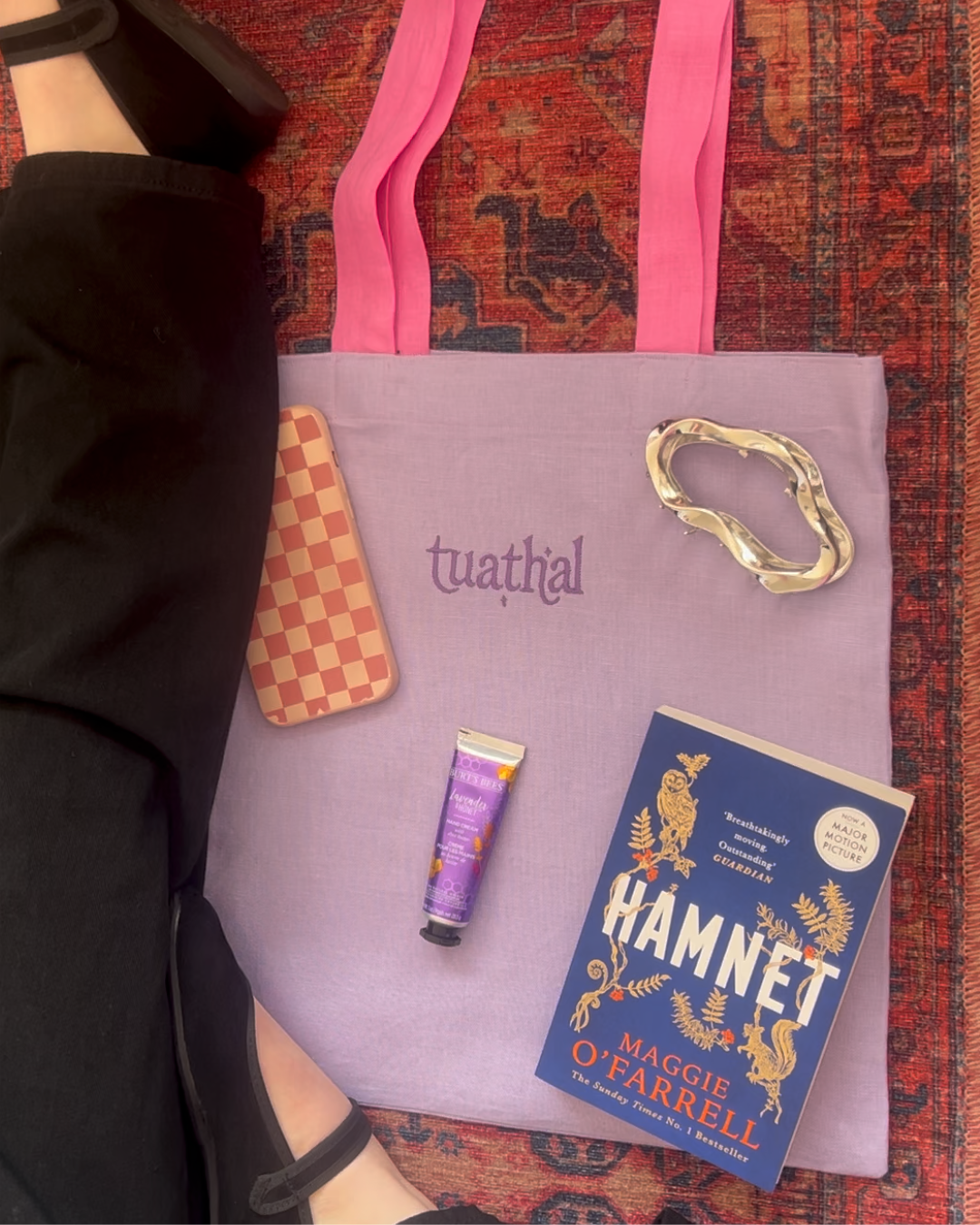 Tuathal purple linen tote bag with every day items laid out