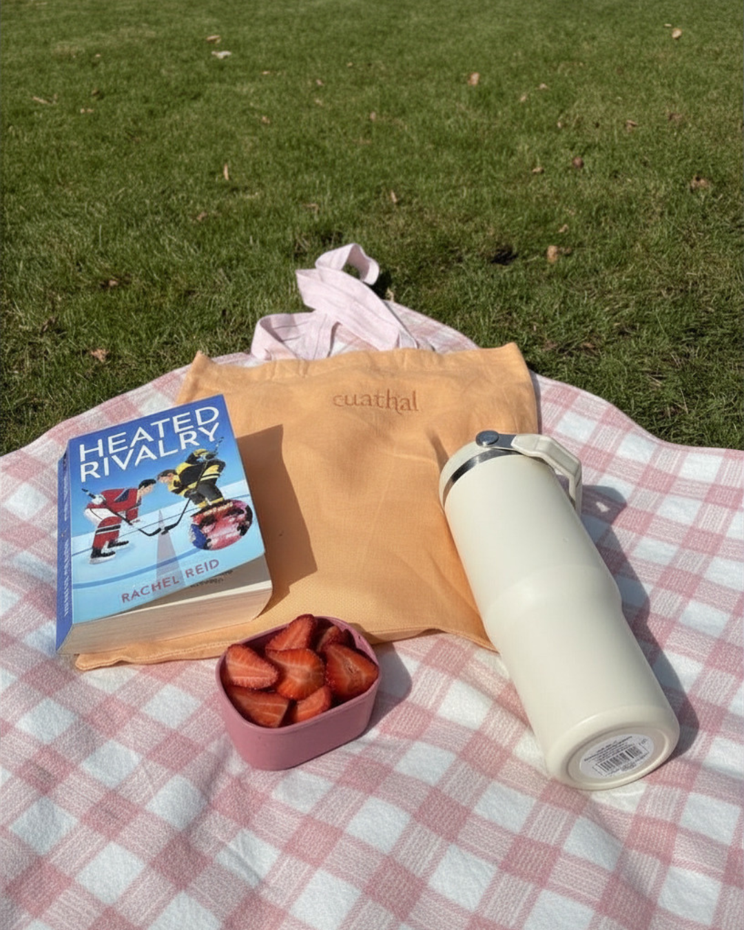 Orange Tuathal Linen Tote bag with light pink straps set up in picnic with fruit, books and drinks
