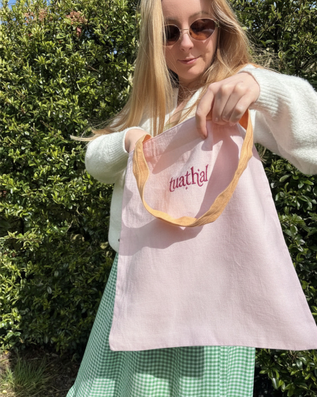 Woman looking through Tuathal light pink linen tote bag 